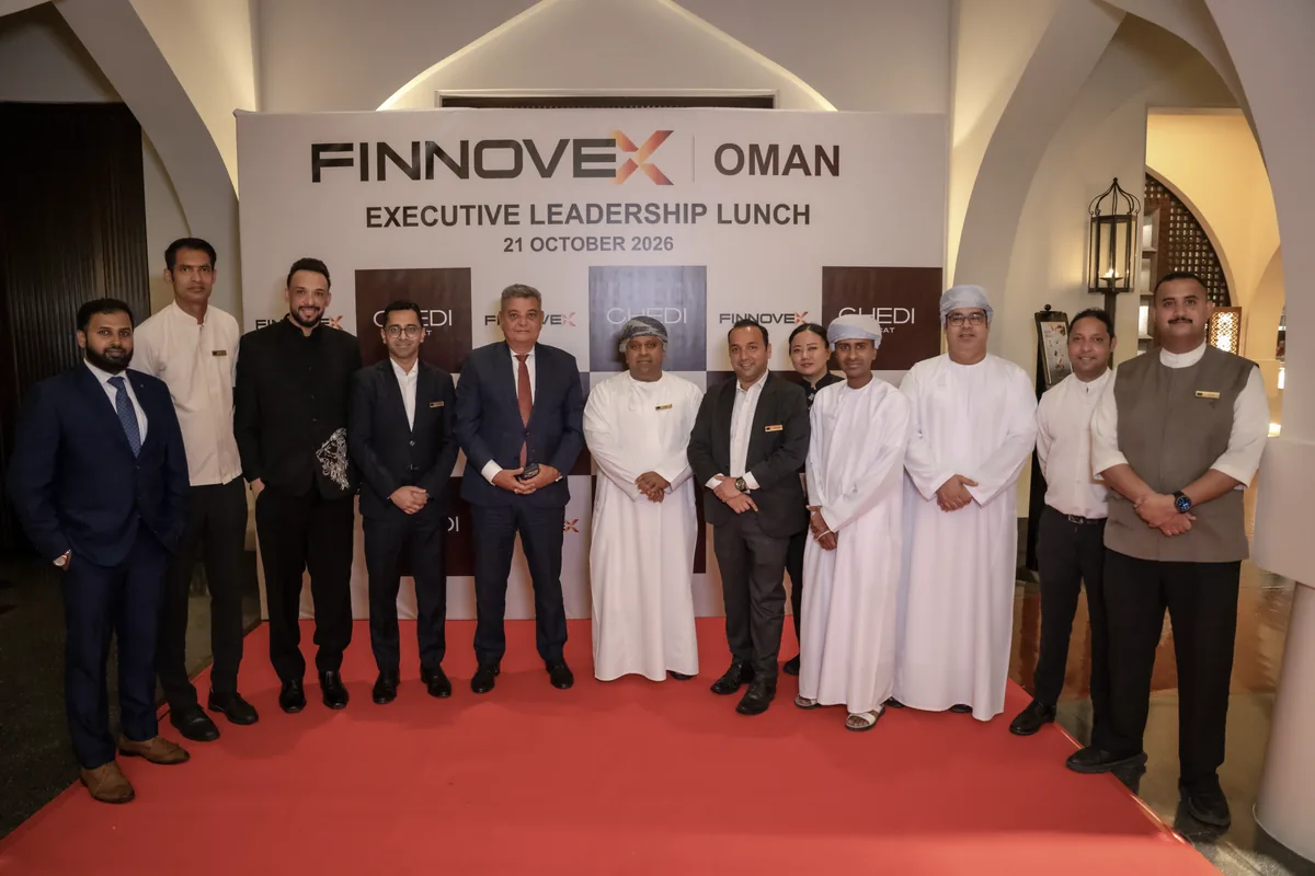 FINNOVEX Oman guests gathered in front of the event backdrop